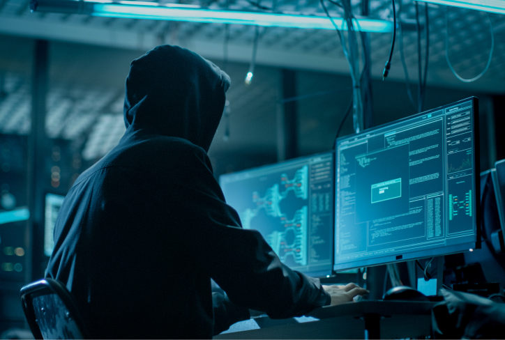Hooded Hacker Breaking into Corporate Data Servers